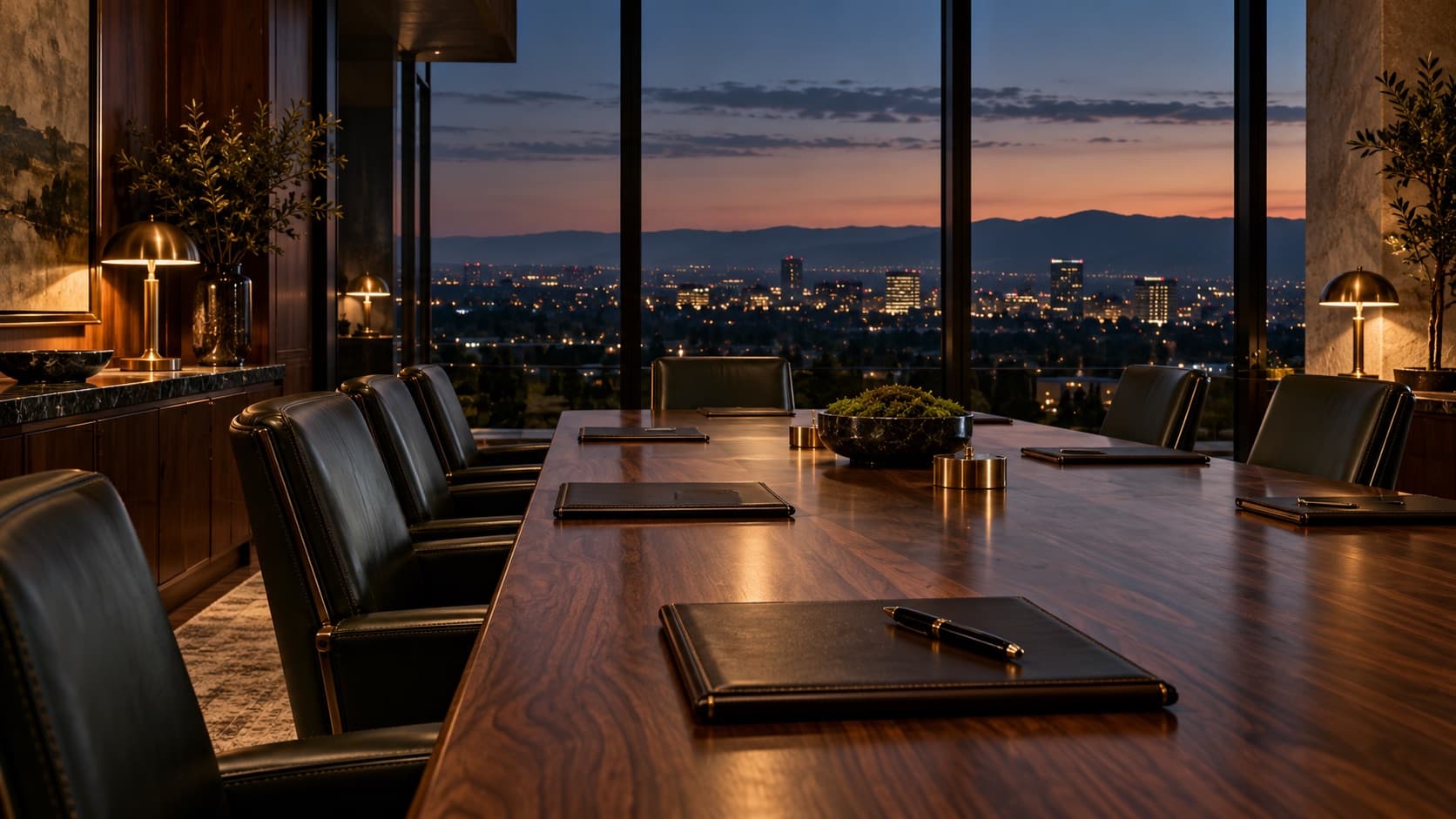 A wood-paneled boardroom at dusk overlooking the city